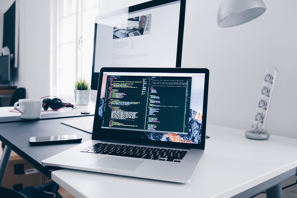 Developer writing source code on laptop